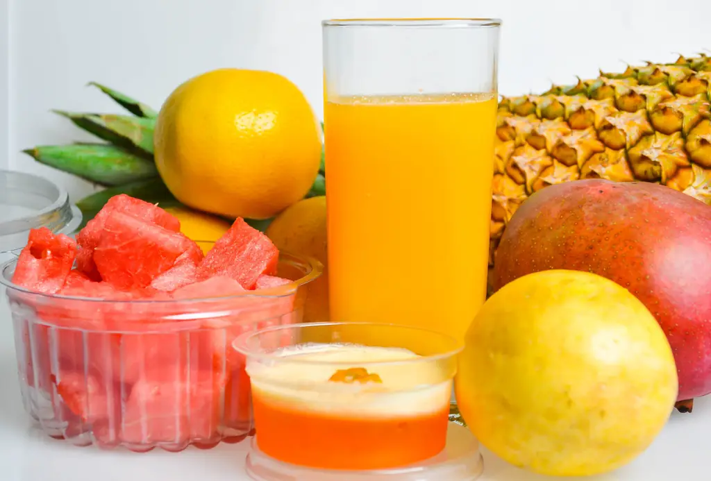 Glass of orange juice with fresh fruit