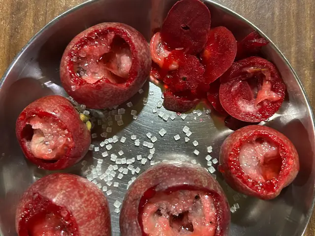 Halved kokum fruits in a steel bowl