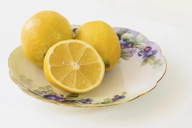 Lemons on a plate, one cut in half