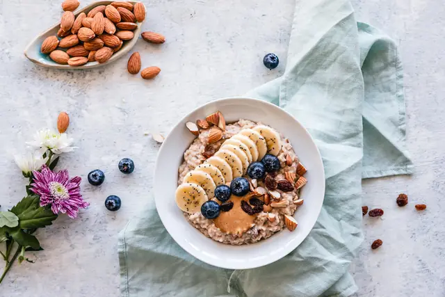 A bowl of oats with fruit and nuts
