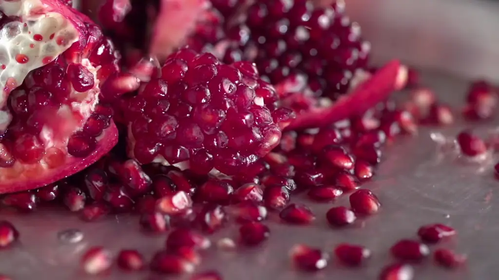 Pomegranate halves and seeds in slow motion