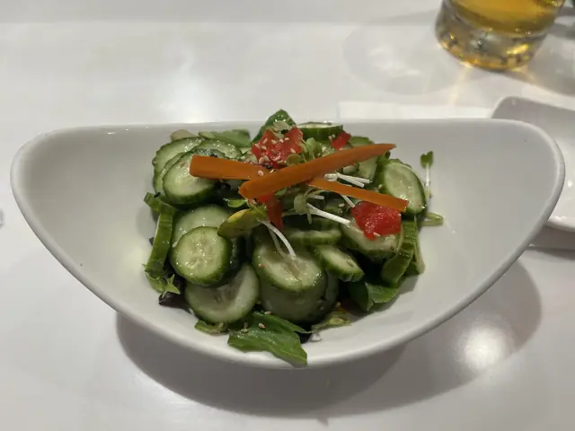 Cucumber salad in a white bowl